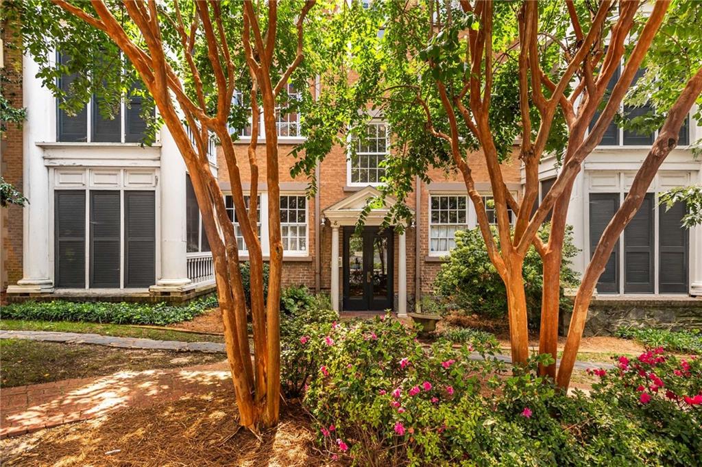 8 Collier Road Northwest, Unit A2 Atlanta, GA 30309 - Photo 1 of 34 front view of a house with a tree