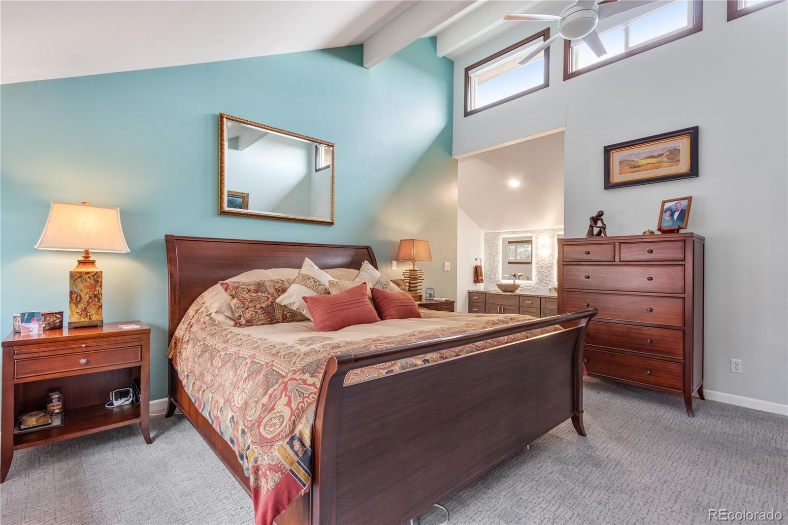 6674 Fairways Drive Longmont, CO 80503 - Photo 19 of 40 a bedroom with a bed and a lamp on dresser