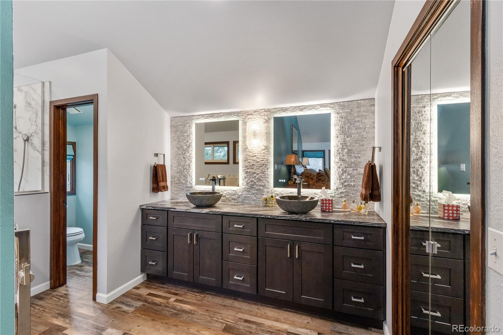 6674 Fairways Drive Longmont, CO 80503 - Photo 20 of 40 a bathroom with a granite countertop sink vanity and mirror