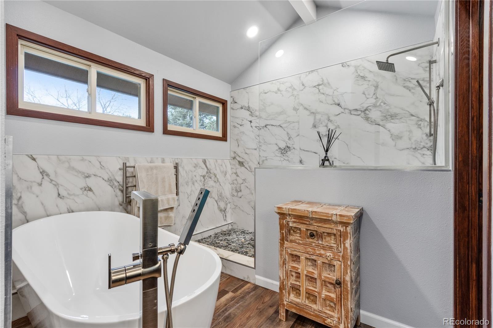 6674 Fairways Drive Longmont, CO 80503 - Photo 21 of 40 a view of a livingroom with chairs wooden floor and front door