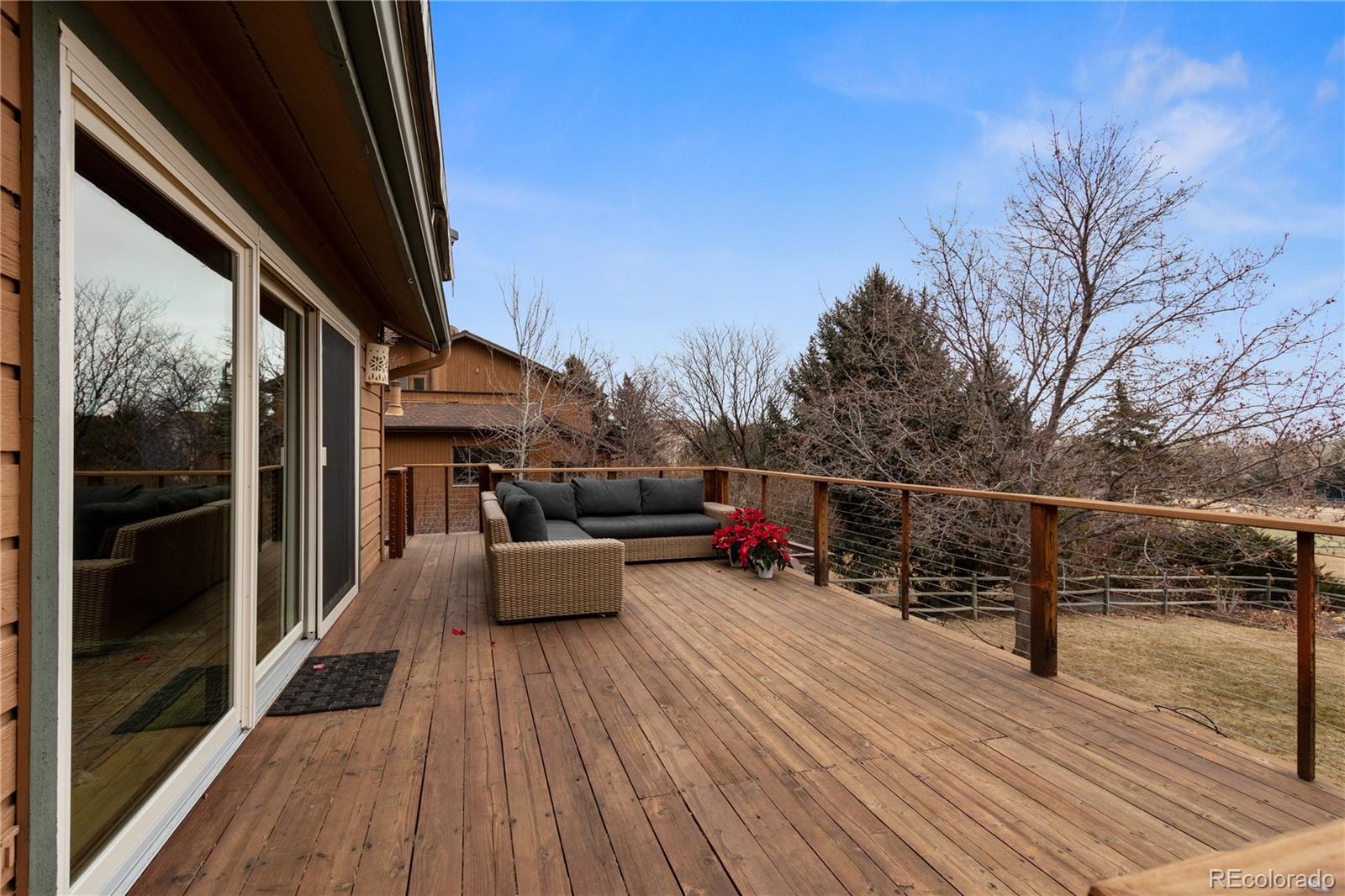 6674 Fairways Drive Longmont, CO 80503 - Photo 33 of 40 a balcony with wooden floor and outdoor seating