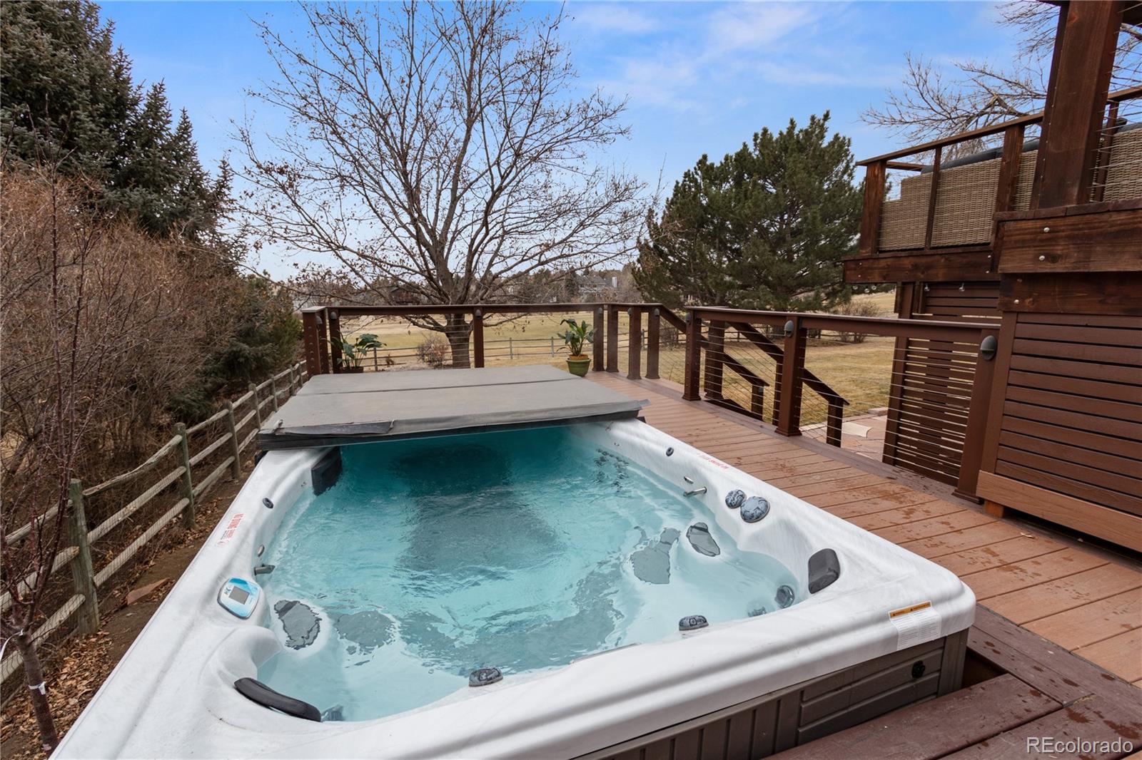 6674 Fairways Drive Longmont, CO 80503 - Photo 34 of 40 a view of roof deck with chairs and wooden fence