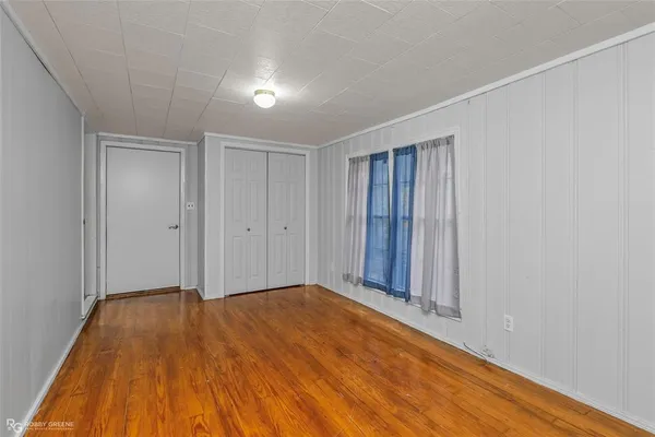 a view of a room with wooden floor