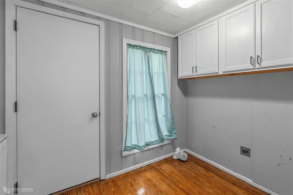 a view of an empty room with window and closet area