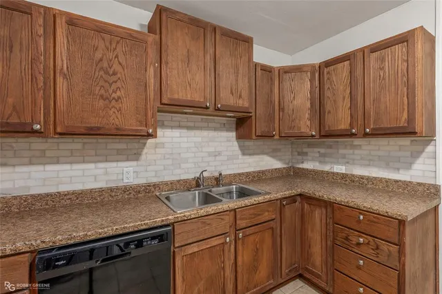 a kitchen with stainless steel appliances granite countertop a sink a stove and cabinets