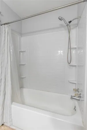 a bathroom with a shower and a bath tub