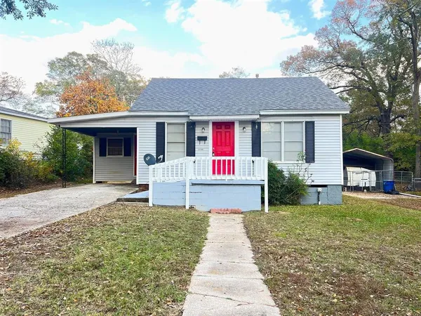 a front view of a house with yard patio and green space