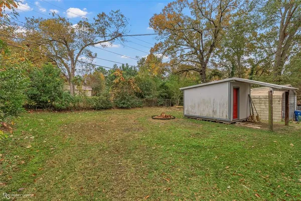a view of a backyard with large trees