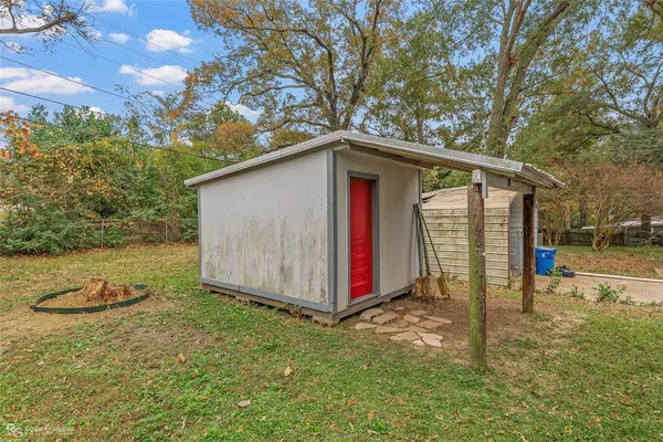 a view of backyard with barn and large trees