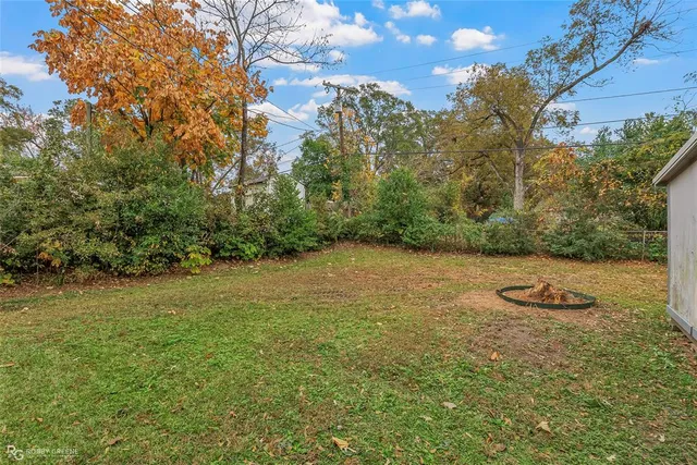 a view of a field with an trees