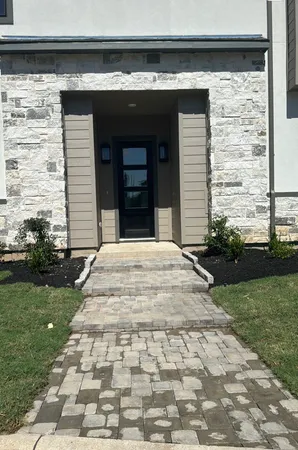 a front view of a house with a garden