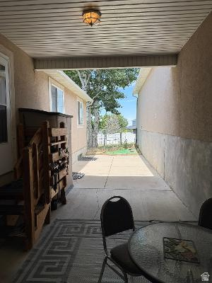 641 East Greystone Way Tooele, UT 84074 - Photo 21 of 30 Covered patio featuring a ceiling-mounted light fixture, concrete flooring, and an open side yard with mature trees