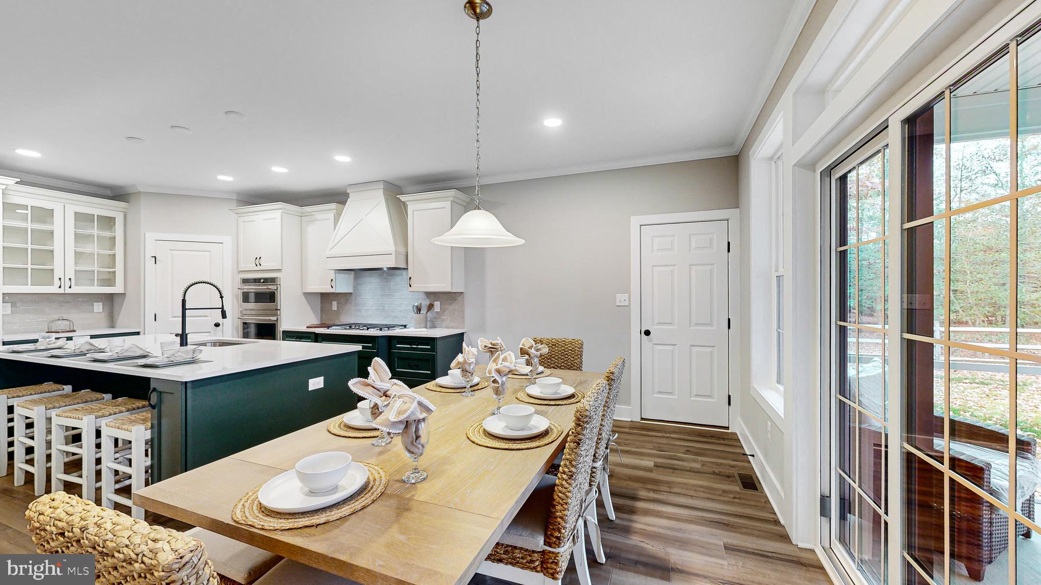 24558 Timber Branch Millsboro, DE 19966 - Photo 8 of 26 a kitchen with stainless steel appliances a dining table chairs and wooden floor