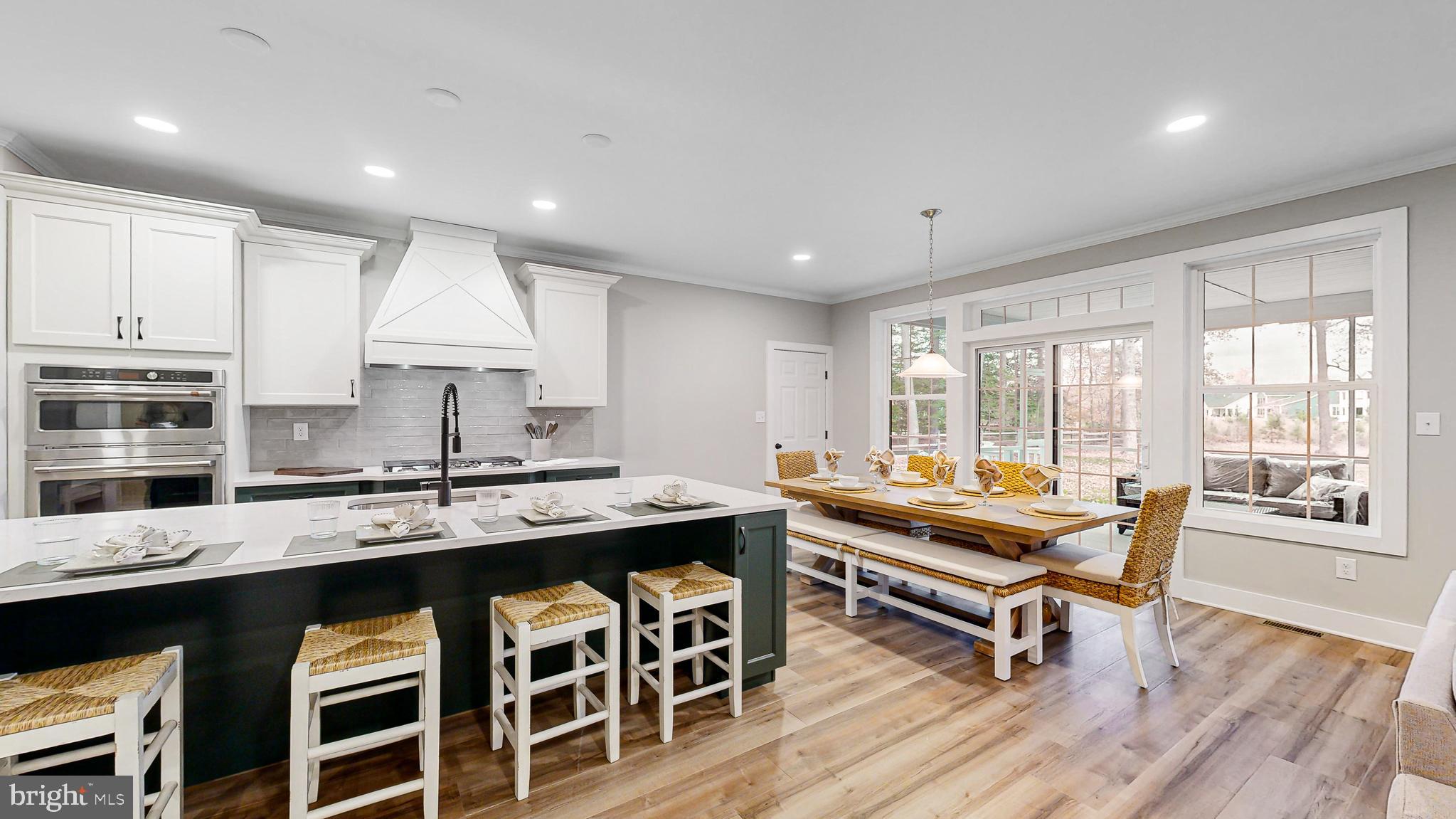 24558 Timber Branch Millsboro, DE 19966 - Photo 9 of 26 a kitchen with stainless steel appliances granite countertop a stove a sink and a refrigerator