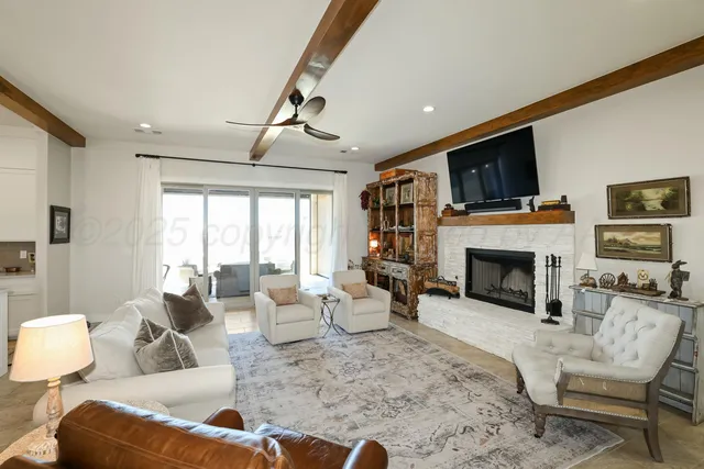 a living room with furniture fireplace and flat screen tv