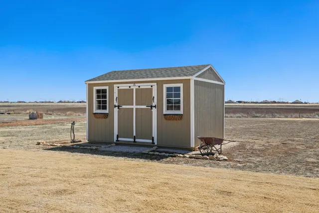 a front view of a building with a yard