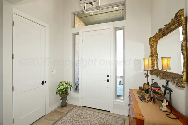 a view of a hallway with workspace and a window