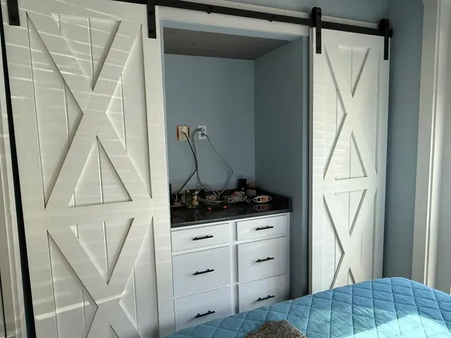 a view of a lake with a yard and large trees