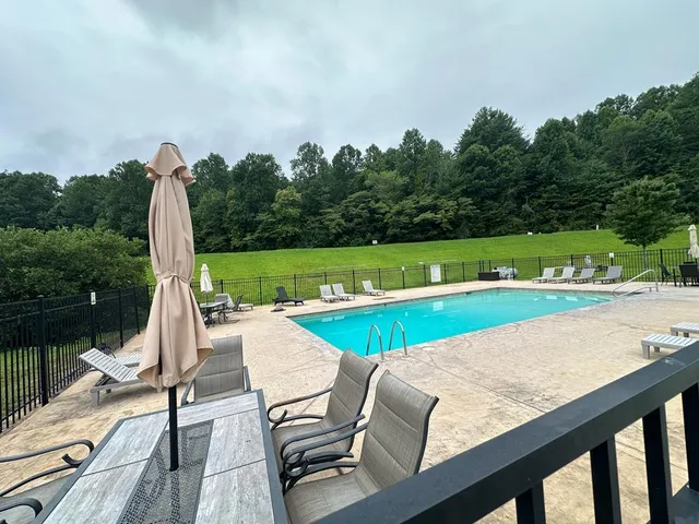 a view of a house with a yard deck and a small yard