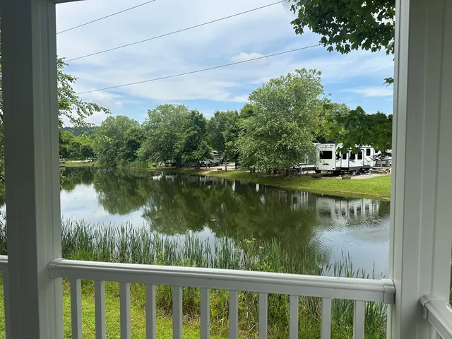 a view of a roof deck with table and chairs under an umbrella with wooden floor