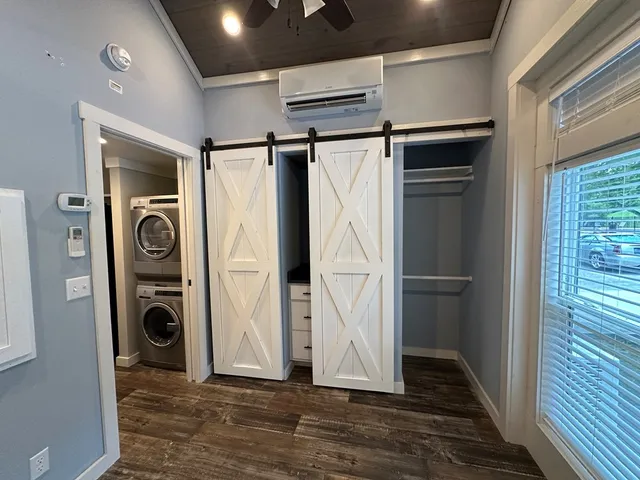a view of a white house with a yard patio and a small yard
