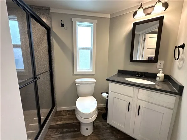 a view of an empty room with a fireplace and a large window