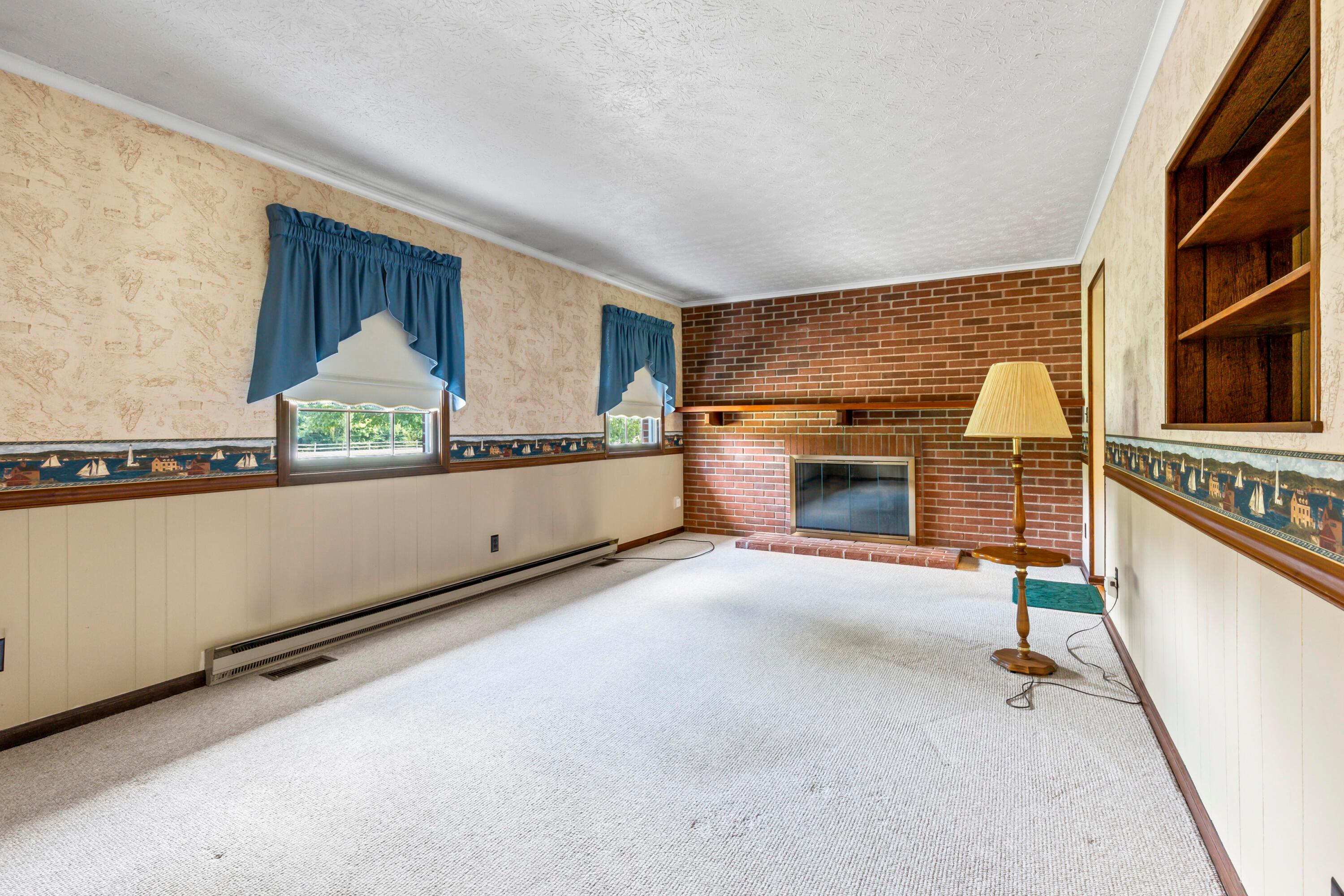 5764 Cheshire Road Galena, OH 43021 - Photo 4 of 59 • Berber carpet
• Papered & panelled walls
• Chair railing
• Crown molding
• Brick fireplace with mantle
& raised hearth