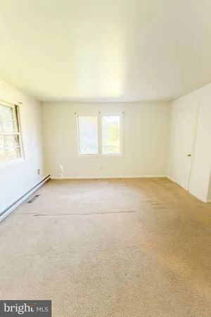 an empty room with a empty space and a window