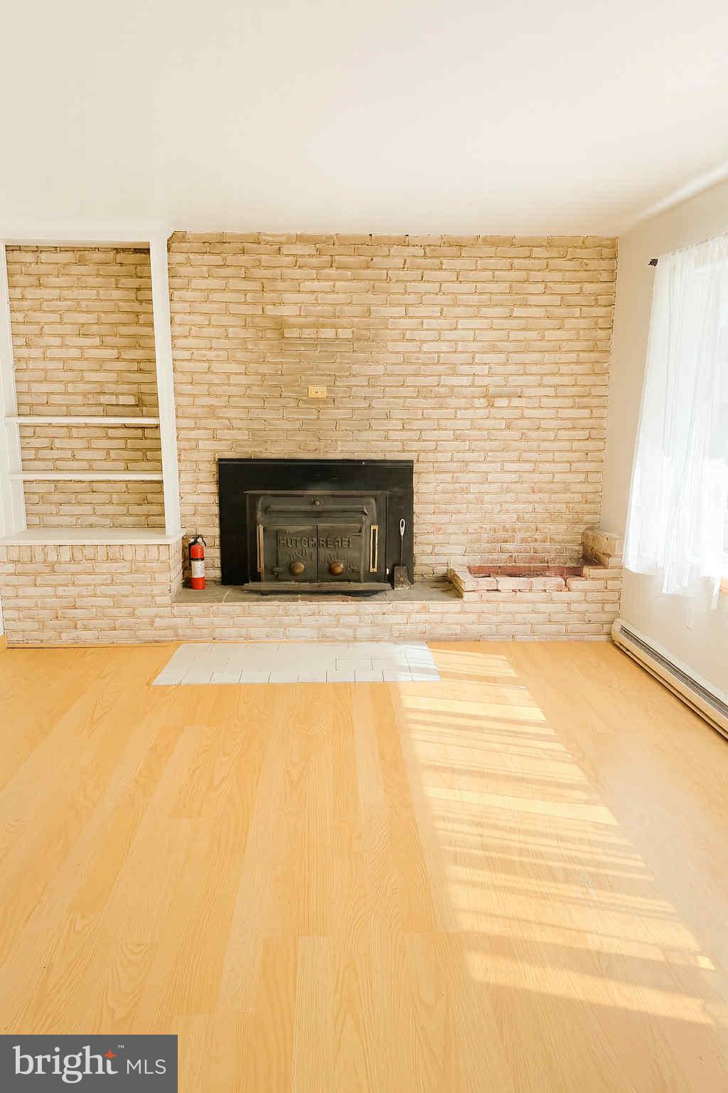 1536 West Trindle Road Carlisle, PA 17015 - Photo 5 of 15 a view of an empty room with a fireplace and a window