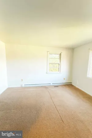 an empty room with a empty space and a window