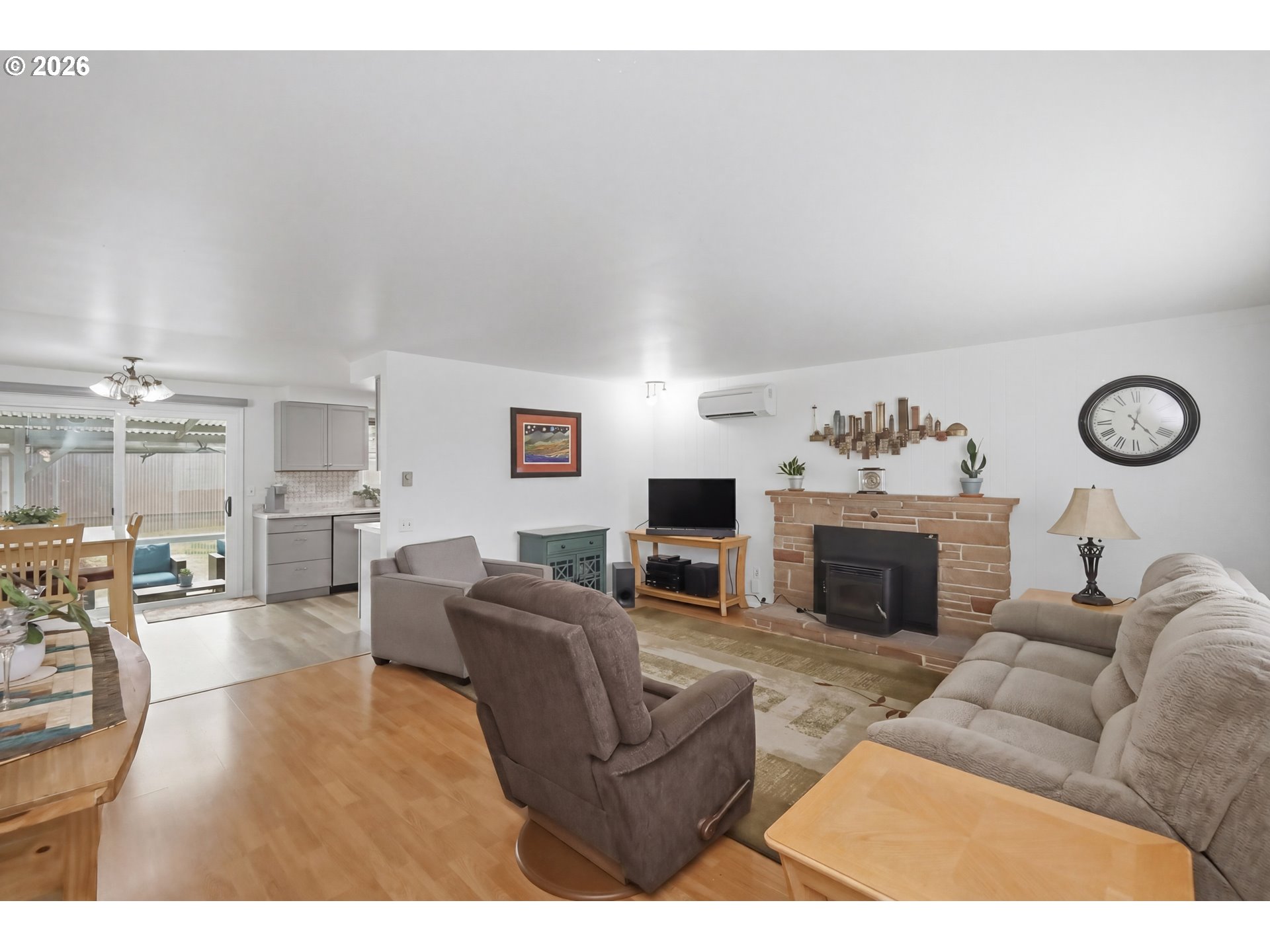 1125 Delrose Drive Springfield, OR 97477 - Photo 5 of 35 a living room with furniture a fireplace and a table