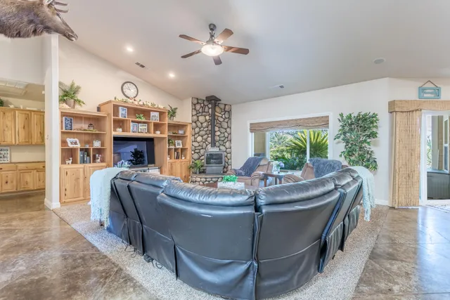 a living room with fireplace furniture and a large window