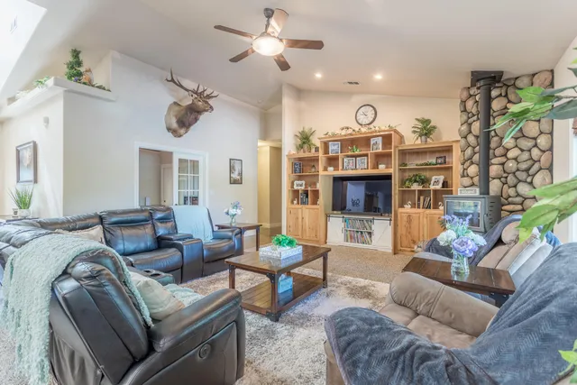 a living room with furniture kitchen view and a fireplace