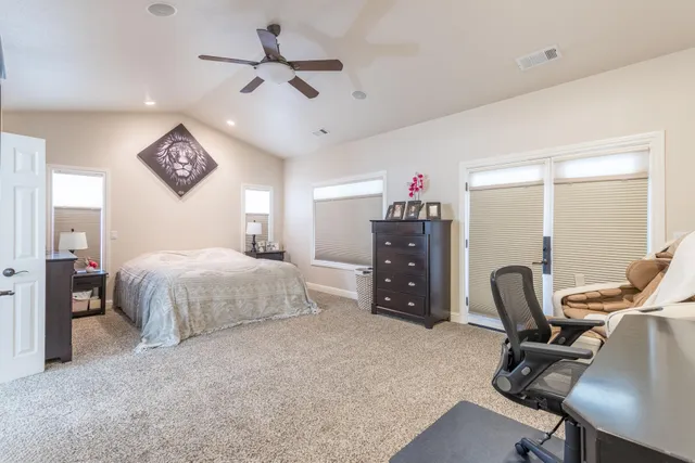 a bedroom with a bed a desk and chair