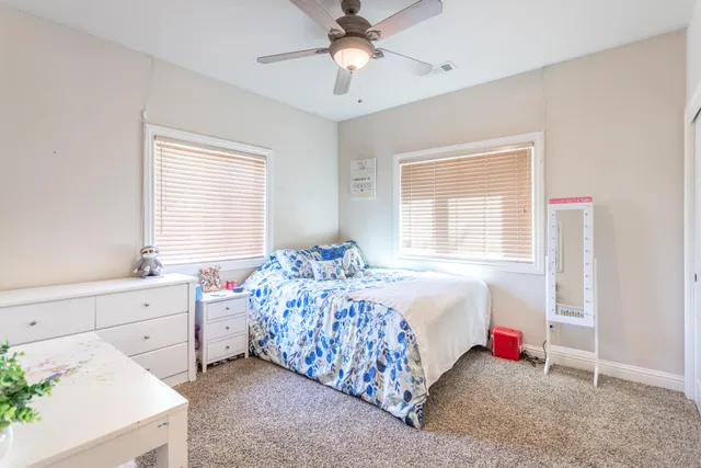 a bedroom with bed and a window