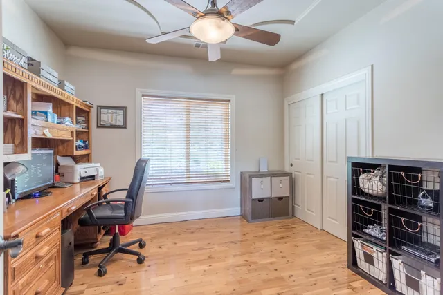 a view of a workspace with furniture and a window