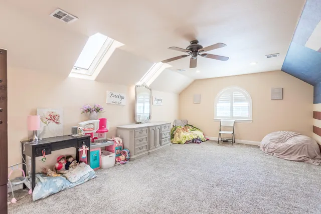 a bedroom with furniture and a fan