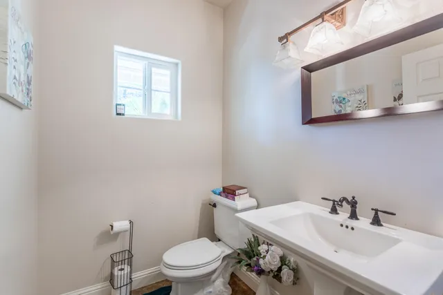 a white toilet sitting next to a bathroom sink