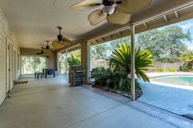 a view of a porch with furniture and a yard