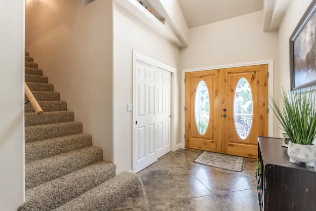 a view of entryway with wooden floor and front door