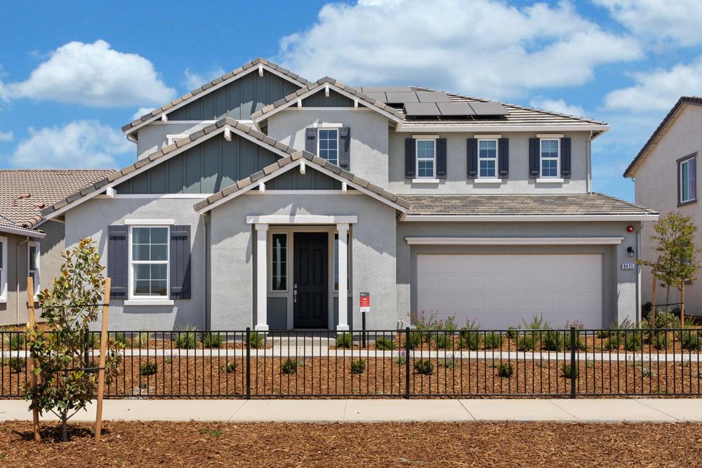 front view of a house with a fence