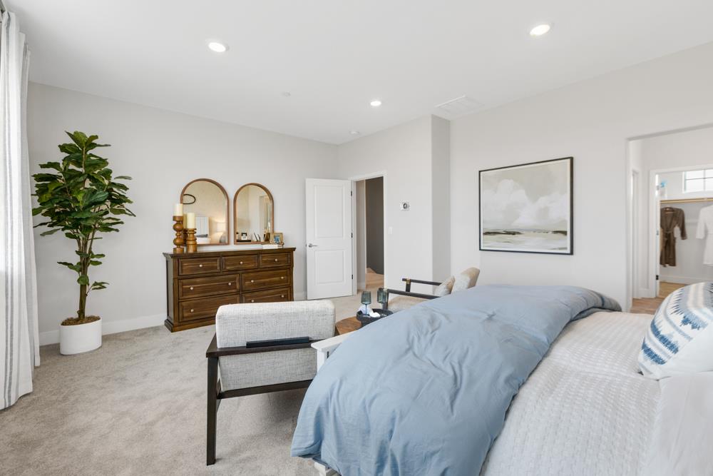 8435 Kyler Road Elk Grove, CA 95757 - Photo 15 of 56 a bedroom with a bed and a potted plant