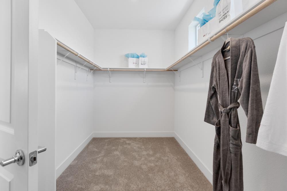8435 Kyler Road Elk Grove, CA 95757 - Photo 20 of 56 a view of walk in closet with clothes