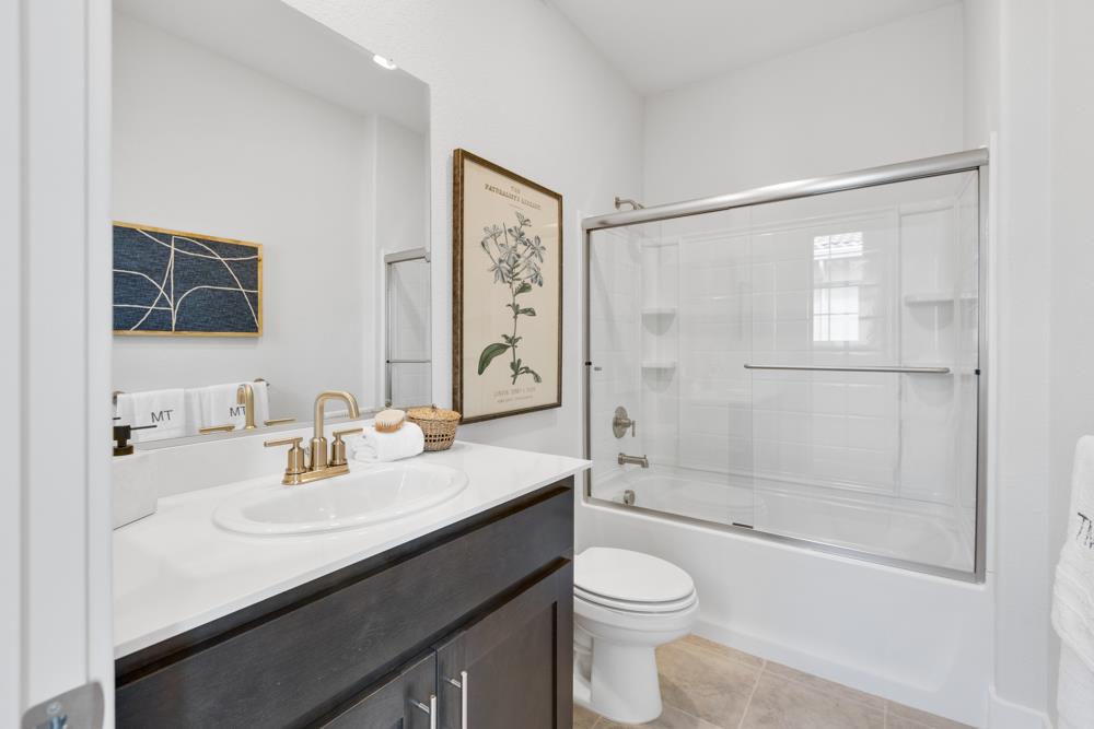 8435 Kyler Road Elk Grove, CA 95757 - Photo 24 of 56 a bathroom with a sink a toilet and shower