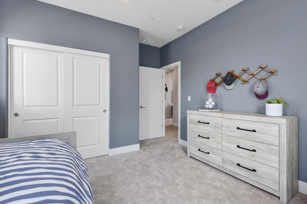 8435 Kyler Road Elk Grove, CA 95757 - Photo 32 of 56 a bedroom with a bed and cabinets