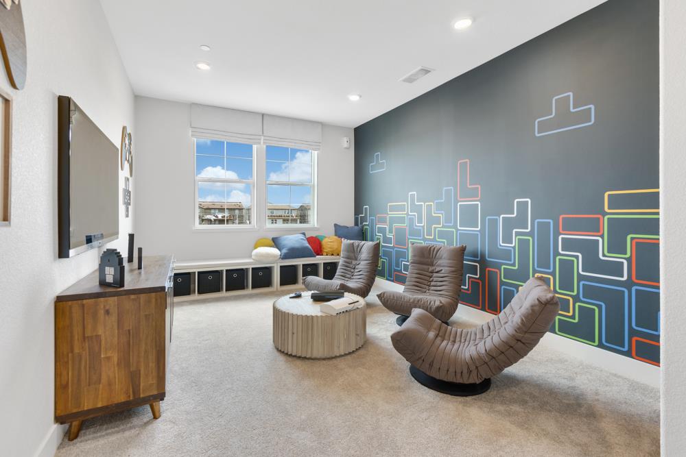 8435 Kyler Road Elk Grove, CA 95757 - Photo 37 of 56 a living room with furniture and a flat screen tv