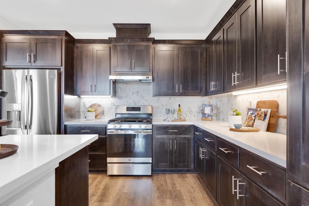 8435 Kyler Road Elk Grove, CA 95757 - Photo 7 of 56 a kitchen with stainless steel appliances granite countertop a sink stove and refrigerator