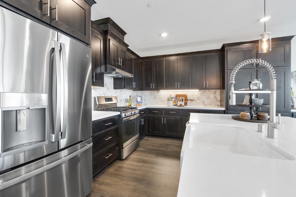 8435 Kyler Road Elk Grove, CA 95757 - Photo 8 of 56 a kitchen with stainless steel appliances granite countertop a refrigerator a sink and a stove
