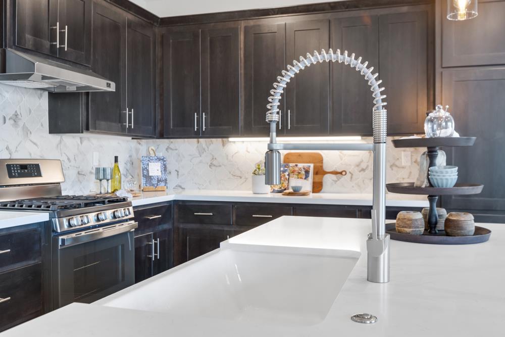 8435 Kyler Road Elk Grove, CA 95757 - Photo 9 of 56 a kitchen with a sink a stove and cabinets