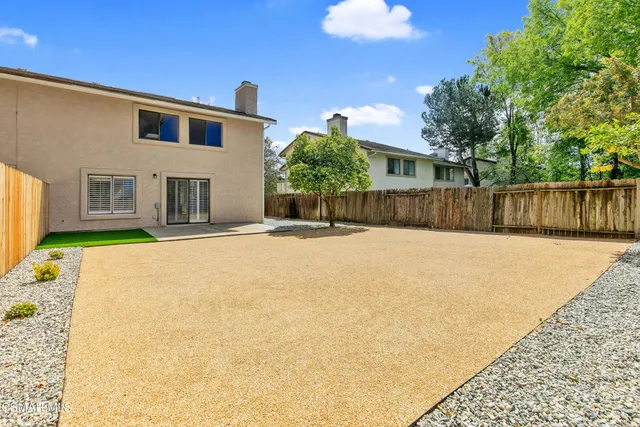 a house that has a tree in front of it